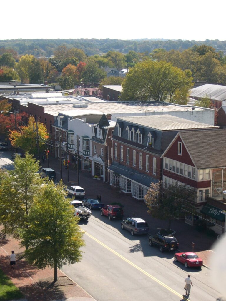 Looking down on High Street in Chestertown with brick storefronts, parked cars and trees turning color