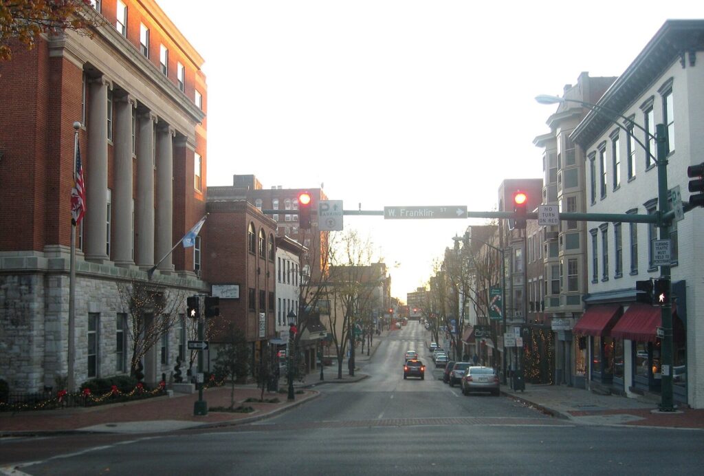 Potomac Street in downtown Hagerstown with brick buildings, traffic lights and a columned bank at the corner