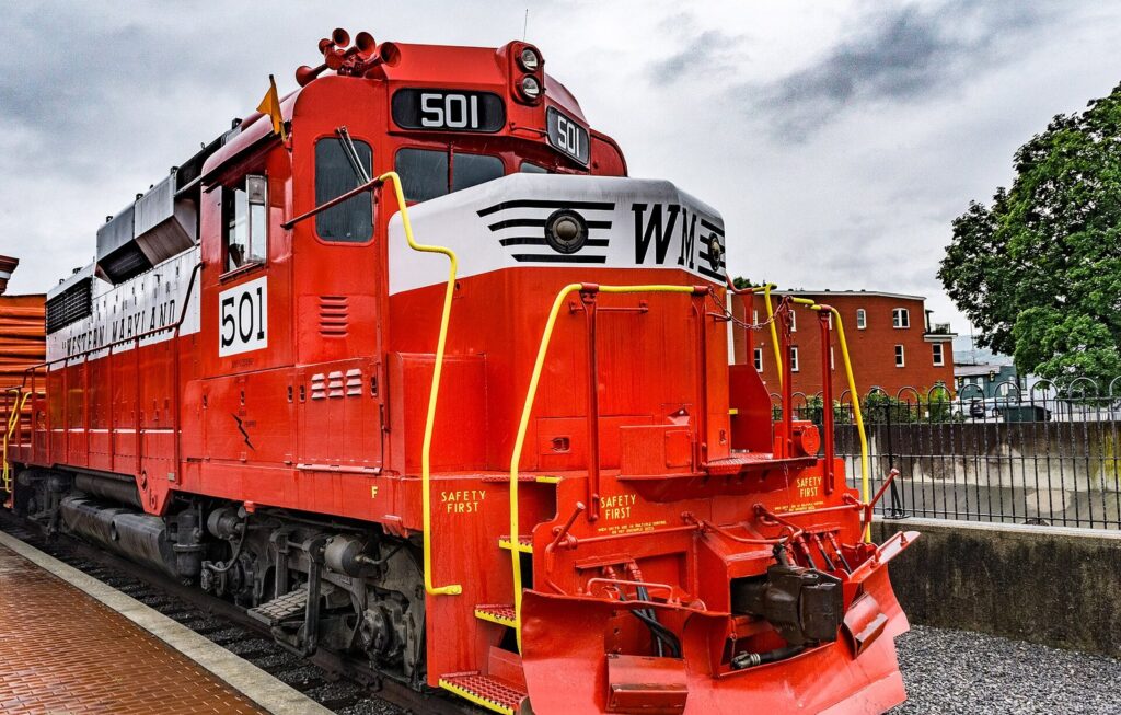 A red and white diesel locomotive numbered 501, painted in old WM colors, at the Cumberland station platform